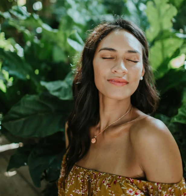 Blog 2 Model with closed eyes in green plants